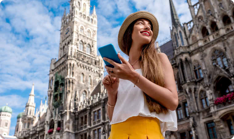 lady using her mobile phone in the central square outside town hall in Munich